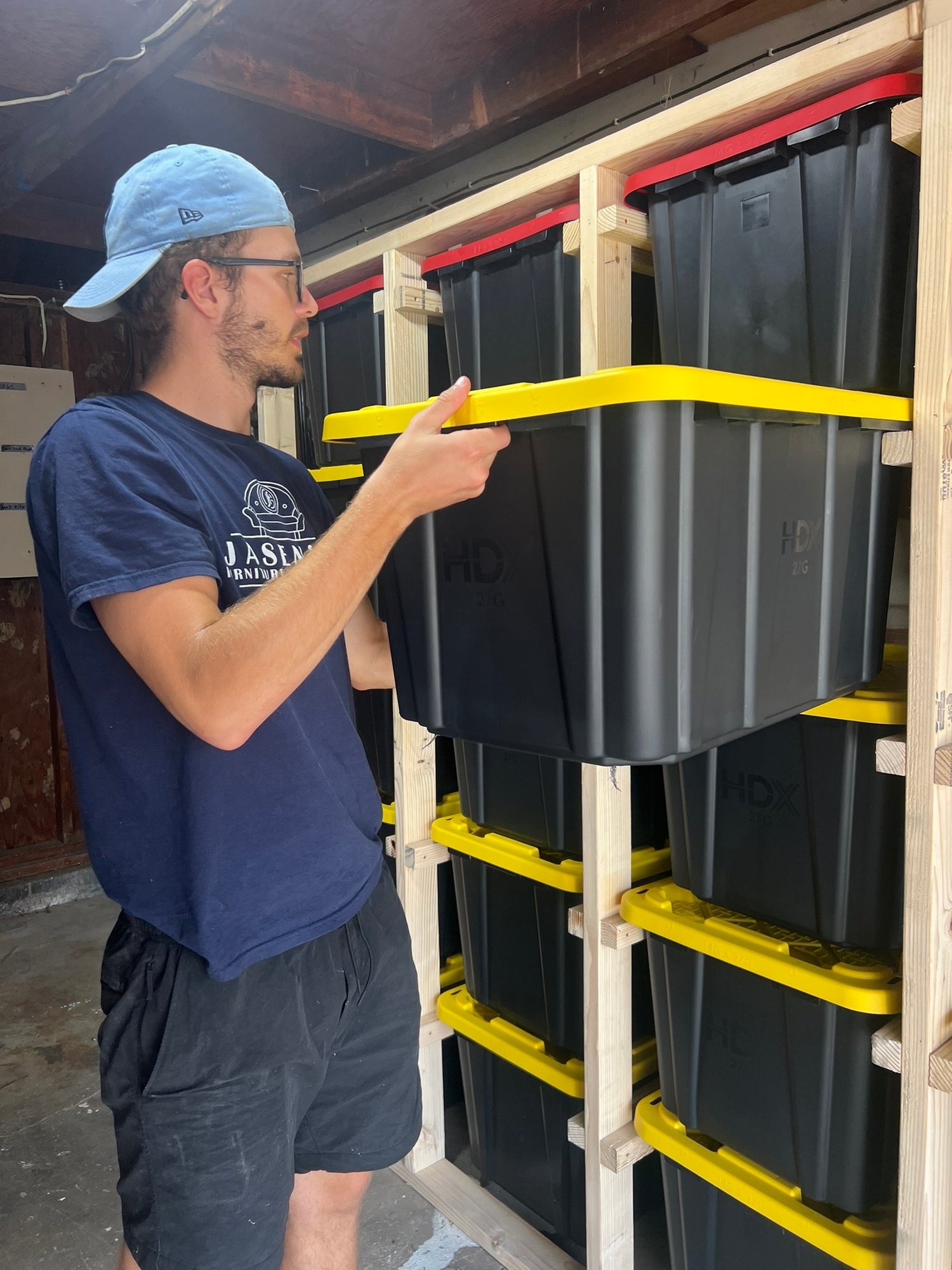 Jasen using a garage storage system with totes